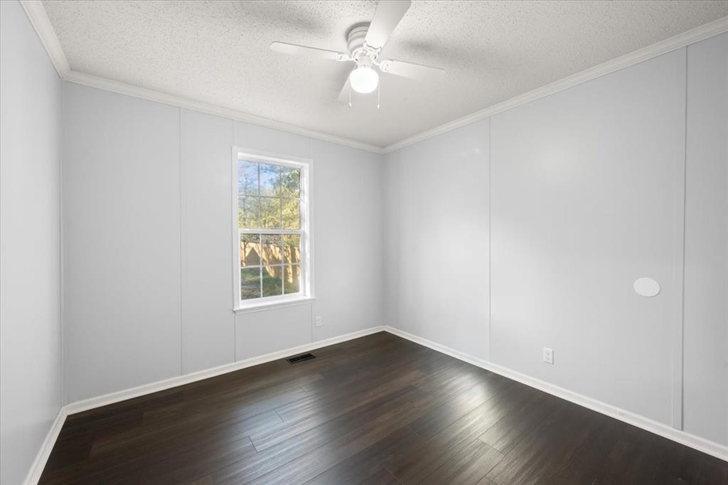 109 Summers Circle Azle, TX 76020 - Photo 24 of 32 an empty room with wooden floor ceiling fan and windows