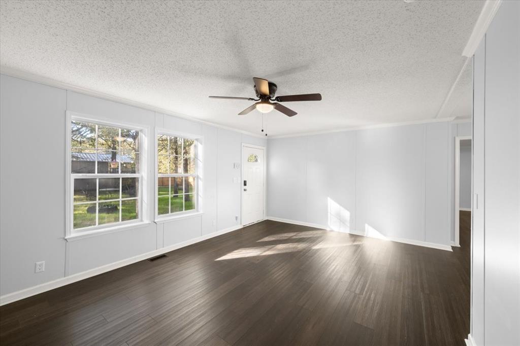 109 Summers Circle Azle, TX 76020 - Photo 7 of 32 an empty room with wooden floor and windows