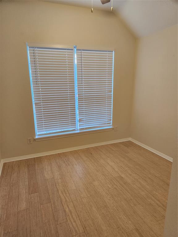 4175 Midrose Trail Dallas, TX 75287 - Photo 12 of 14 Bedroom 3. Room featuring wood-finish flooring, a vaulted ceiling, and a ceiling fan