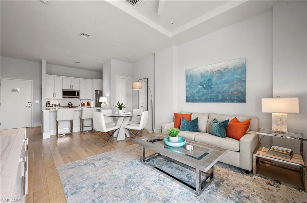 101 8th Street South, Unit 206 Naples, FL 34102 - Photo 1 of 26 a living room with furniture and view of kitchen