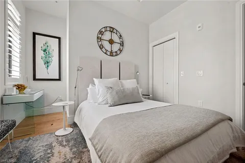 a bedroom with a bed and paintings on the wall