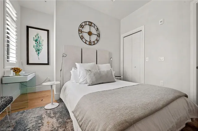 a bedroom with a bed and paintings on the wall