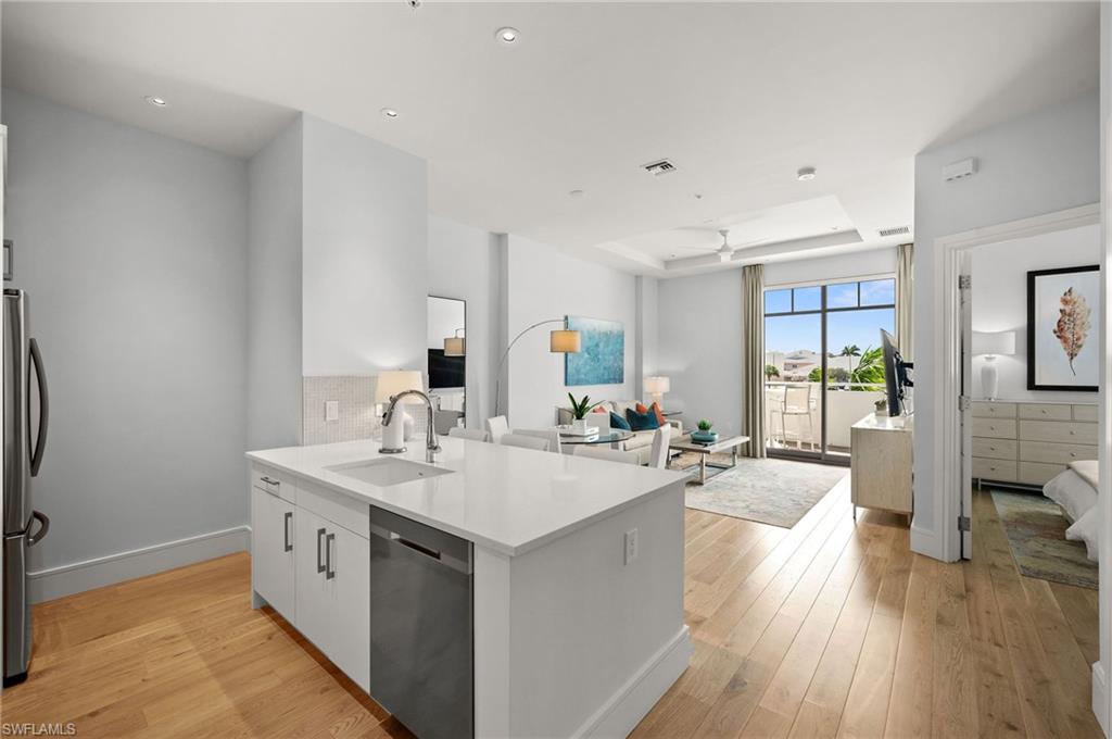 101 8th Street South, Unit 206 Naples, FL 34102 - Photo 3 of 26 a large white kitchen with a large window