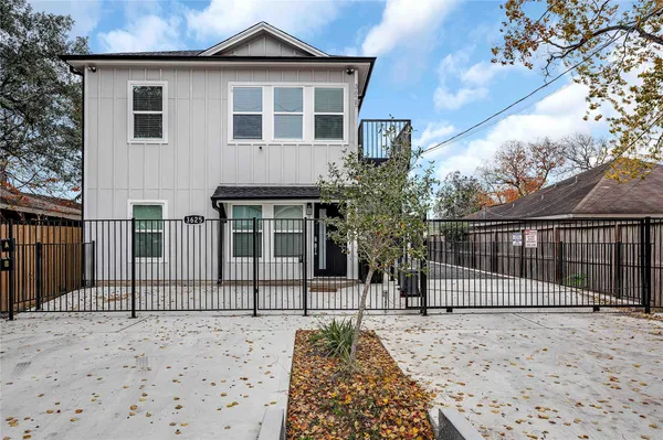 a view of a house with a fence