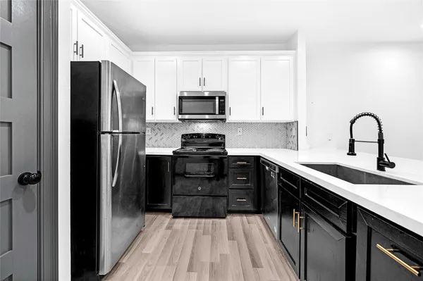 a kitchen with a refrigerator stove and sink