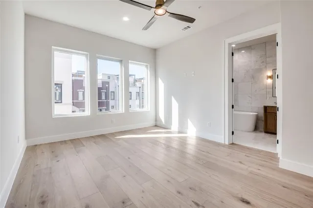 a spacious bedroom with a bed and a large window