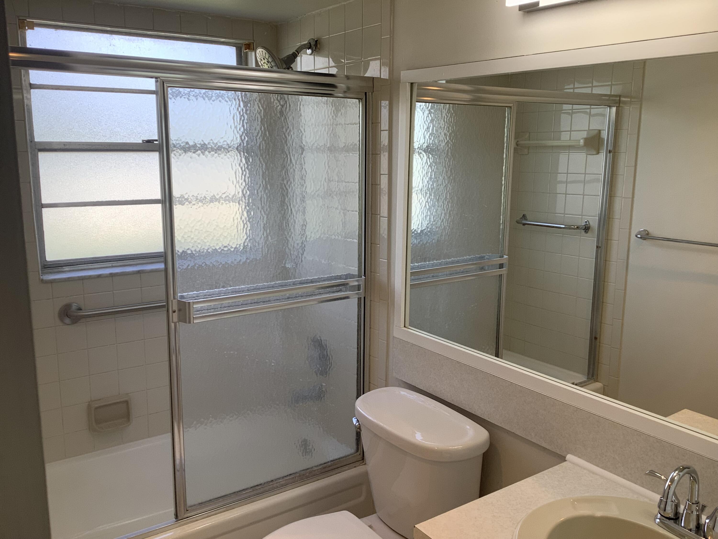 560 Fanshaw North, Unit 560 Boca Raton, FL 33434 - Photo 18 of 26 a bathroom with a shower and toilet