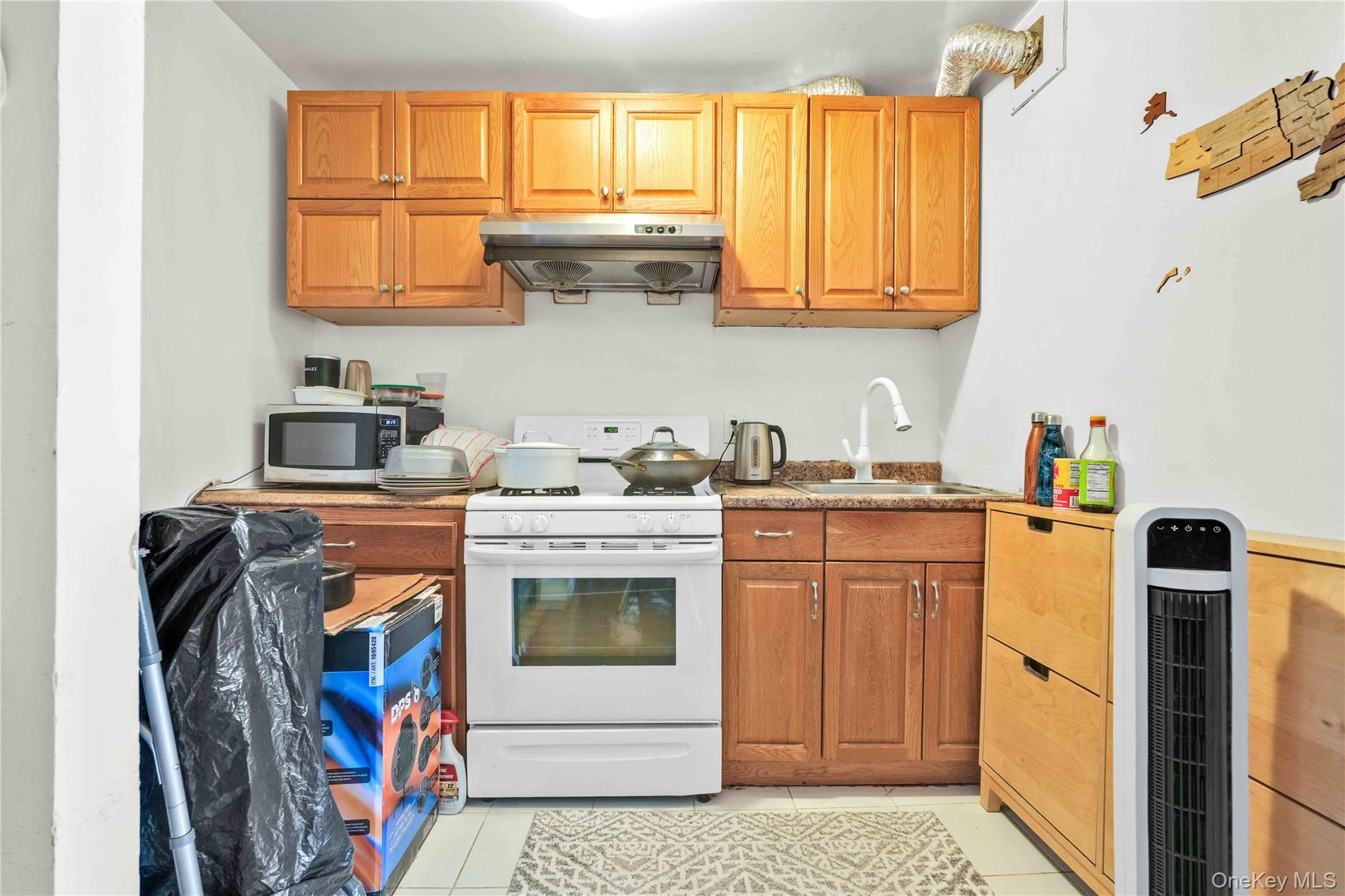58-03 Calloway Street, Unit 5A Queens, NY 11368 - Photo 11 of 19 a kitchen with stainless steel appliances granite countertop a stove a sink and a refrigerator