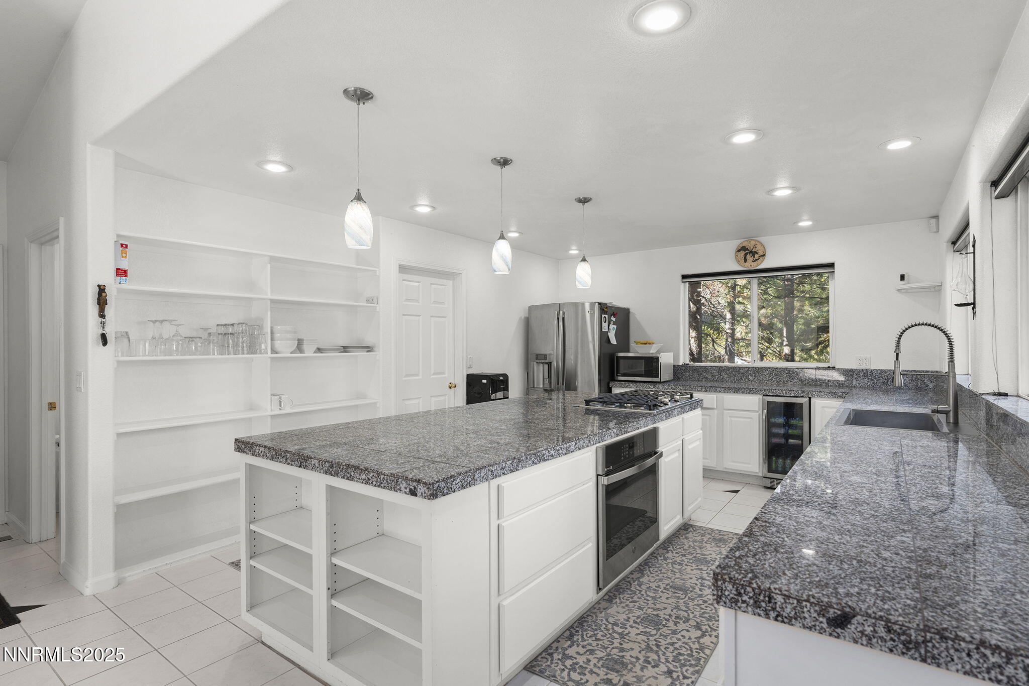 50 Sunridge Drive Reno, NV 89511 - Photo 3 of 29 a kitchen with white cabinets and counter space