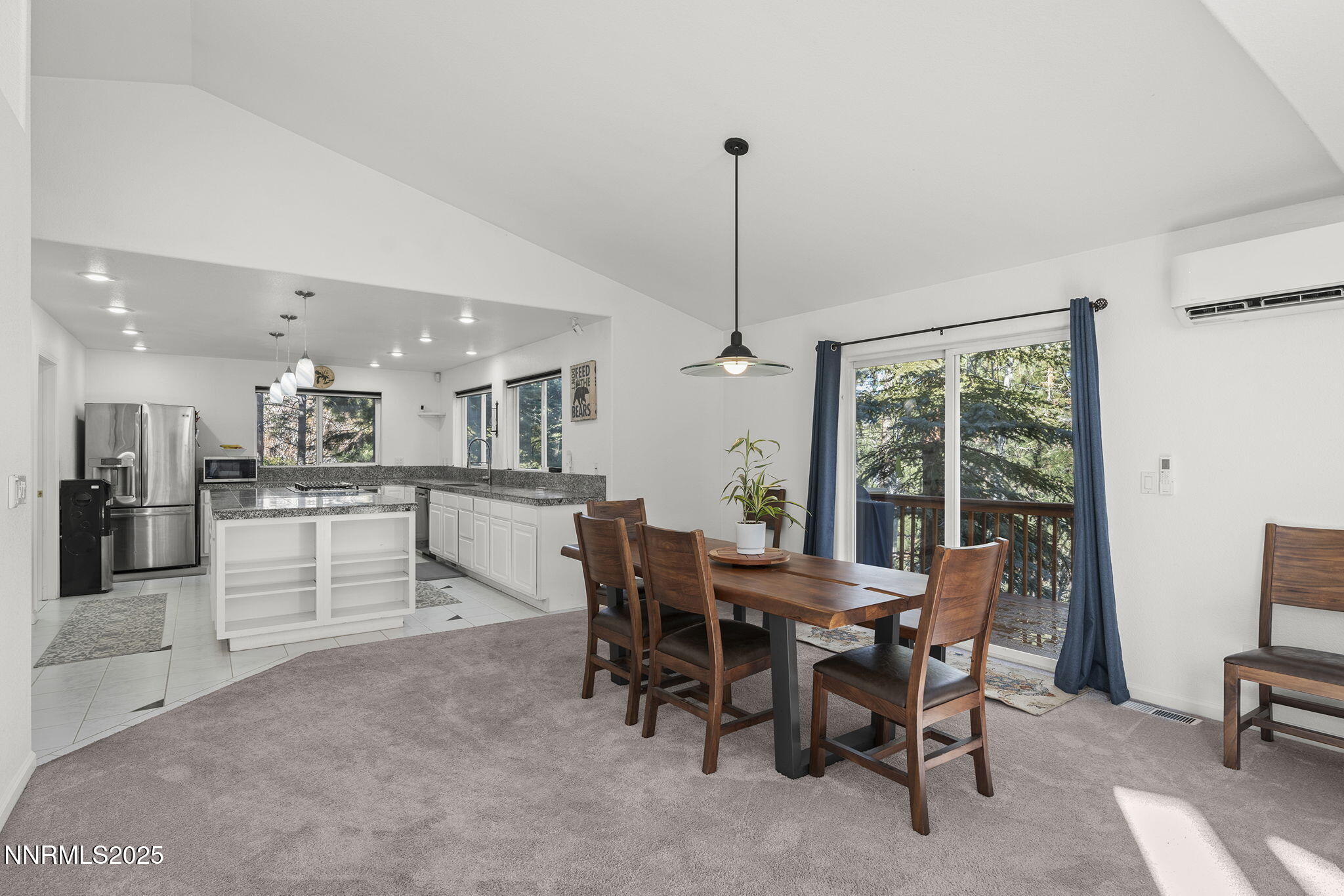 50 Sunridge Drive Reno, NV 89511 - Photo 7 of 29 a view of a dining room and livingroom with furniture wooden floor a rug a painting and a chandelier
