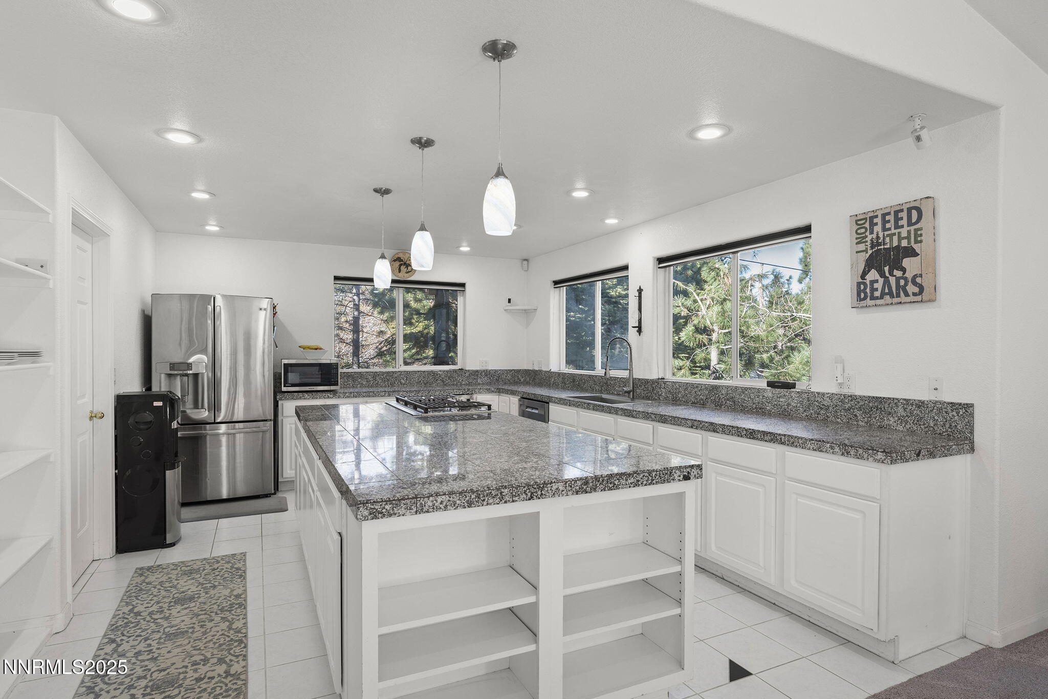 50 Sunridge Drive Reno, NV 89511 - Photo 9 of 29 a kitchen with stainless steel appliances granite countertop a sink refrigerator and cabinets