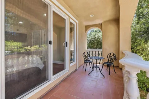 a dining room with furniture and a floor to ceiling window