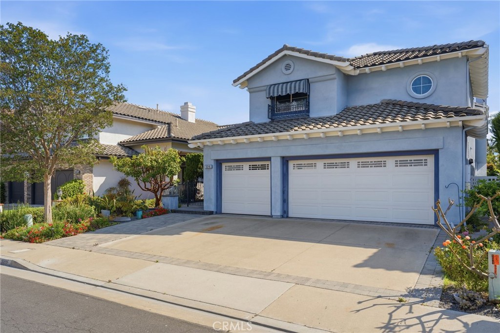 9916 Fonte Road Cypress, CA 90630 - Photo 1 of 27 a front view of a house with a garden and plants