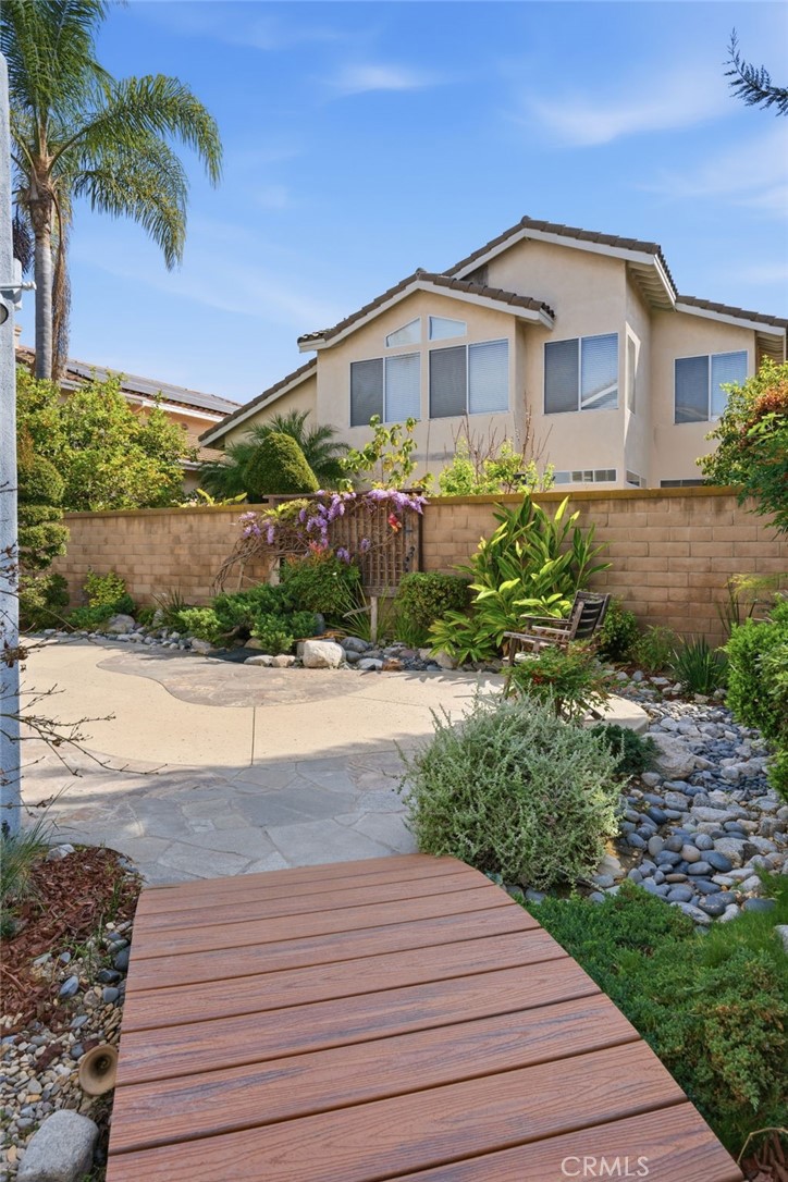9916 Fonte Road Cypress, CA 90630 - Photo 23 of 27 a front view of a house with a yard and potted plants