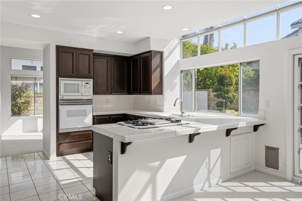 9916 Fonte Road Cypress, CA 90630 - Photo 8 of 27 a kitchen with a stove a refrigerator and a sink