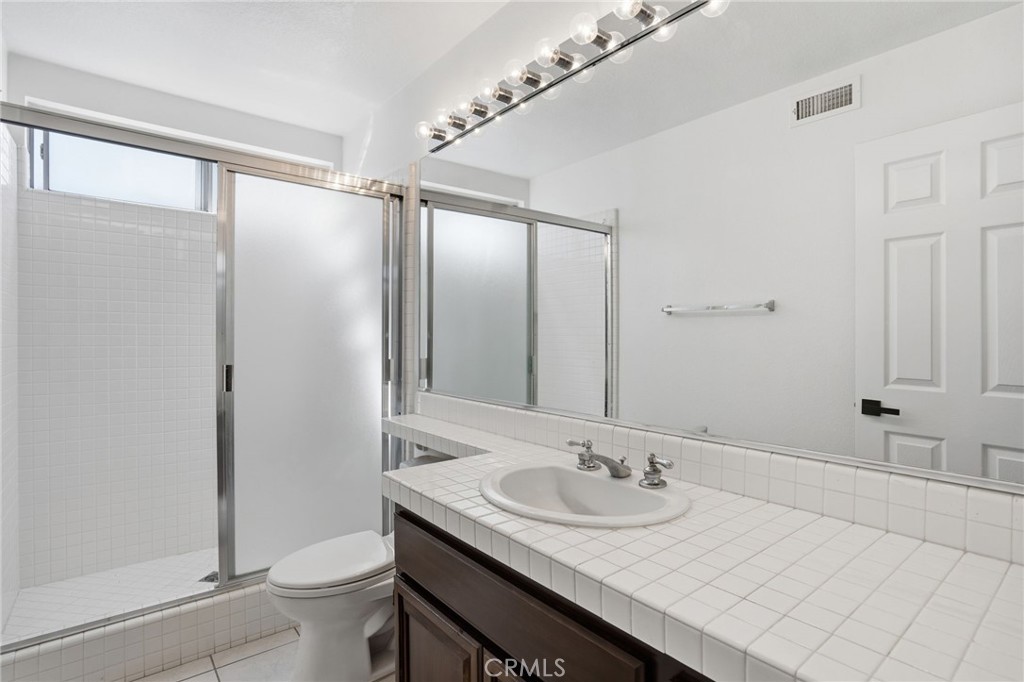 9916 Fonte Road Cypress, CA 90630 - Photo 10 of 27 a bathroom with a sink and a mirror