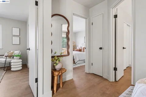 a bedroom with a bed and painting on the wall