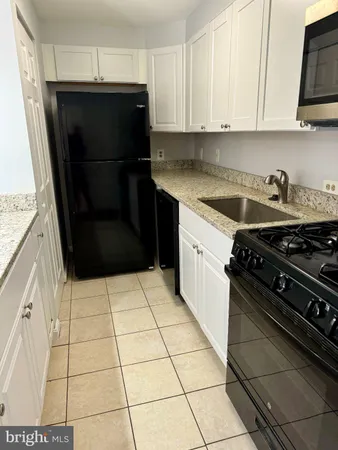 a kitchen with a stove and a refrigerator