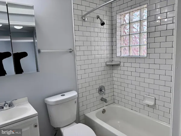 a bathroom with a toilet and a bathtub