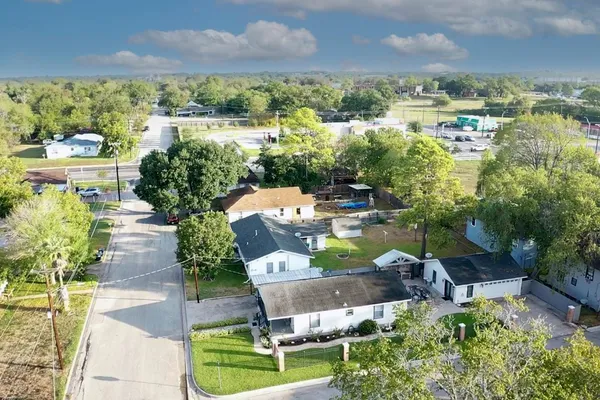 an aerial view of a house with a yard basket ball court and outdoor seating