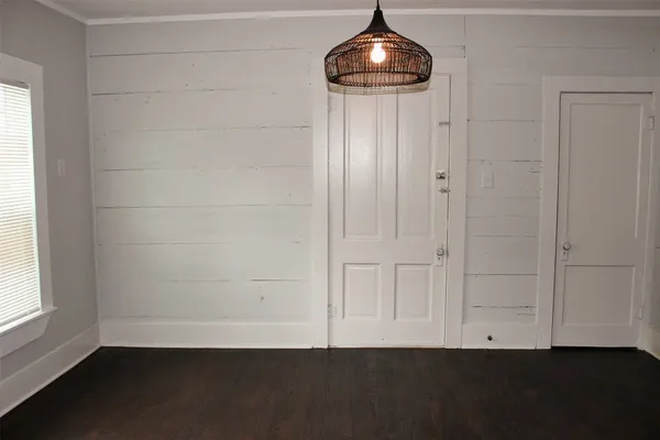 an empty room with a ceiling fan and window
