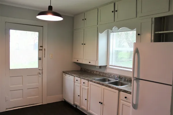 a kitchen with stainless steel appliances granite countertop a sink a stove and a refrigerator