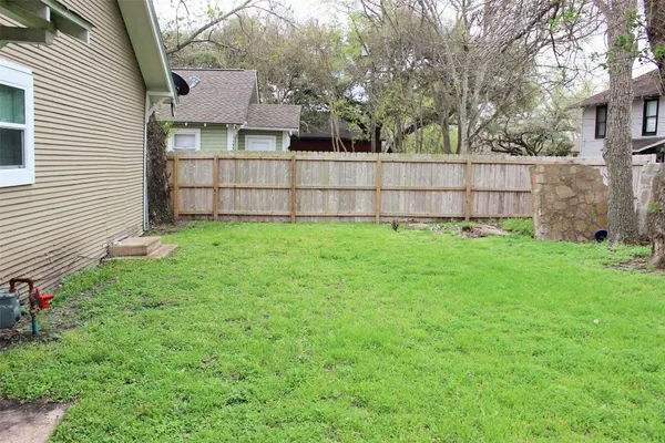 a view of a backyard with a small cabin and a chair