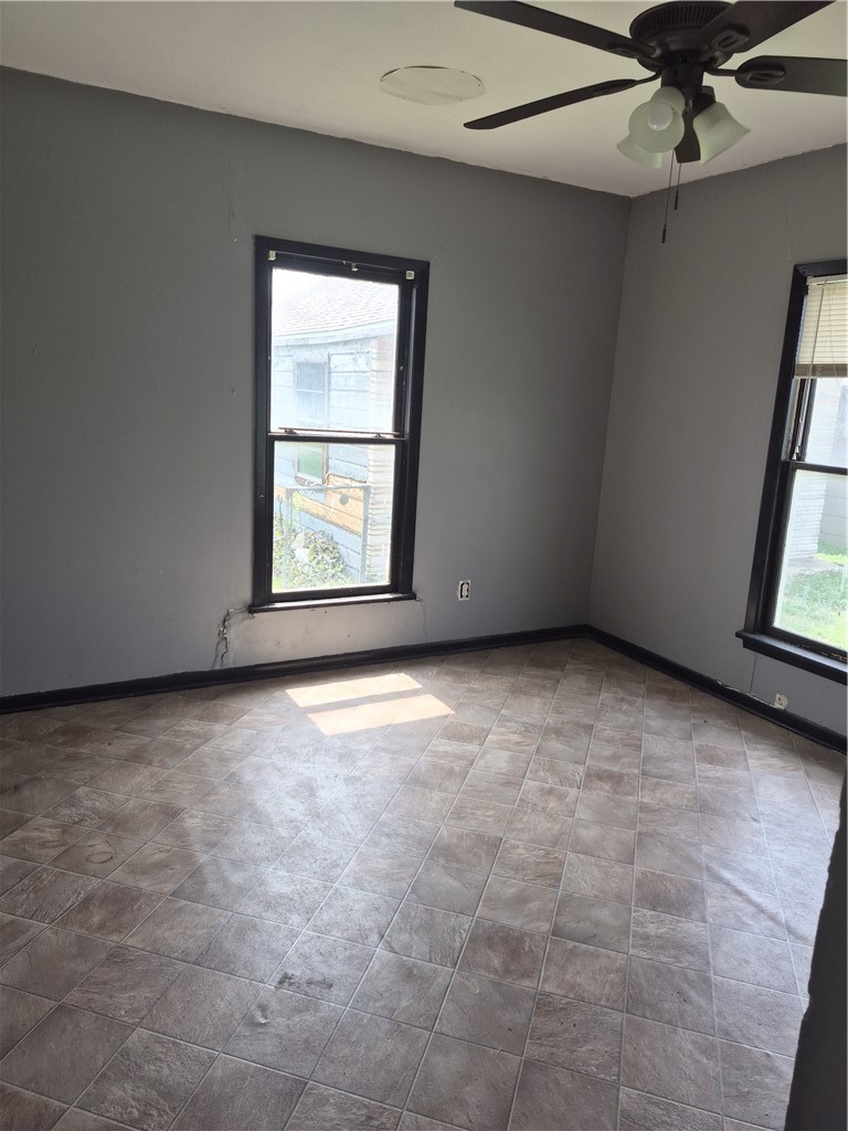 202 North Gregory Gregory, TX 78374 - Photo 11 of 19 an empty room with windows and fan