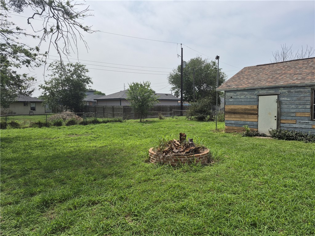 202 North Gregory Gregory, TX 78374 - Photo 18 of 19 a backyard of a house with table and chairs