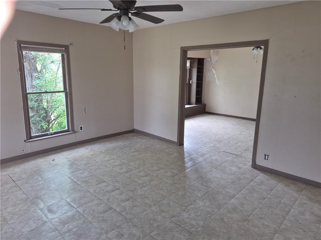 202 North Gregory Gregory, TX 78374 - Photo 6 of 19 an empty room with a window and a ceiling fan