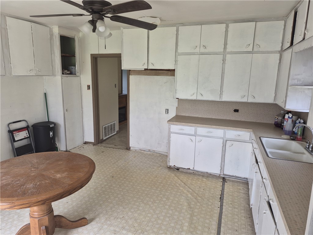 202 North Gregory Gregory, TX 78374 - Photo 8 of 19 a kitchen with white cabinets and stainless steel appliances