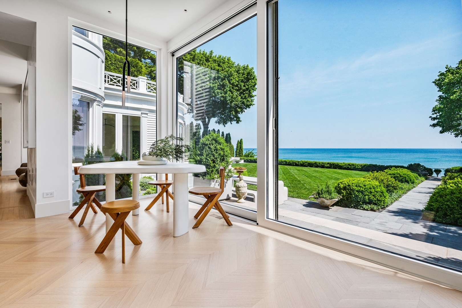 219 Sheridan Road Kenilworth, IL 60043 - Photo 9 of 63 a view of a patio with a table and chairs and potted plants