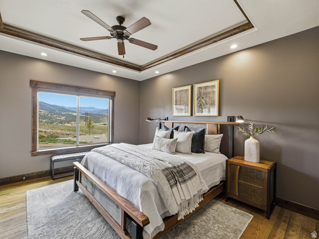 402 Shadow Hill Road Wanship, UT 84017 - Photo 22 of 90 Bedroom featuring a mountain view, wood finished floors, a ceiling fan, recessed lighting, and a raised ceiling