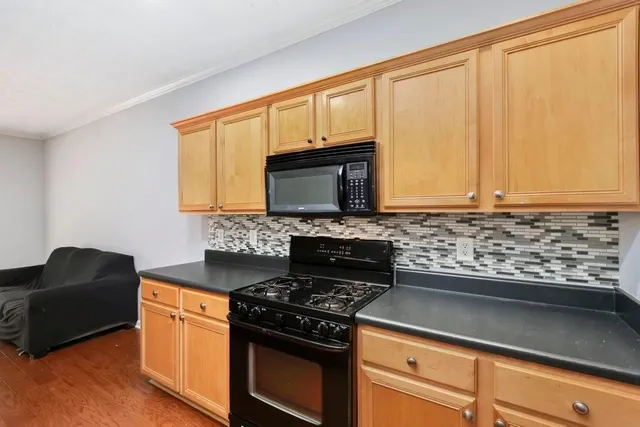 a kitchen with granite countertop cabinets stainless steel appliances and a sink