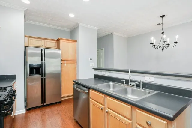 a bathroom with a sink a light fixture a vanity and a large mirror