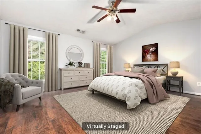 a bedroom with a bed a couch and a window