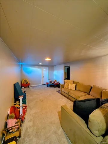 a living room with furniture a couch and gym equipment