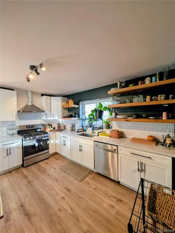 a kitchen with stainless steel appliances a stove a sink dishwasher and a refrigerator
