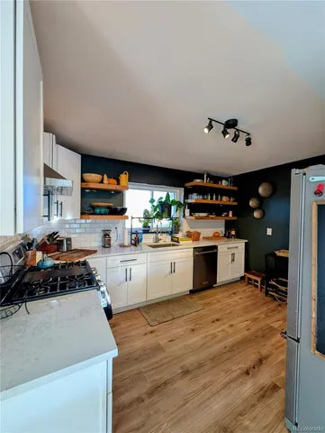 a kitchen with stainless steel appliances a stove sink and cabinets