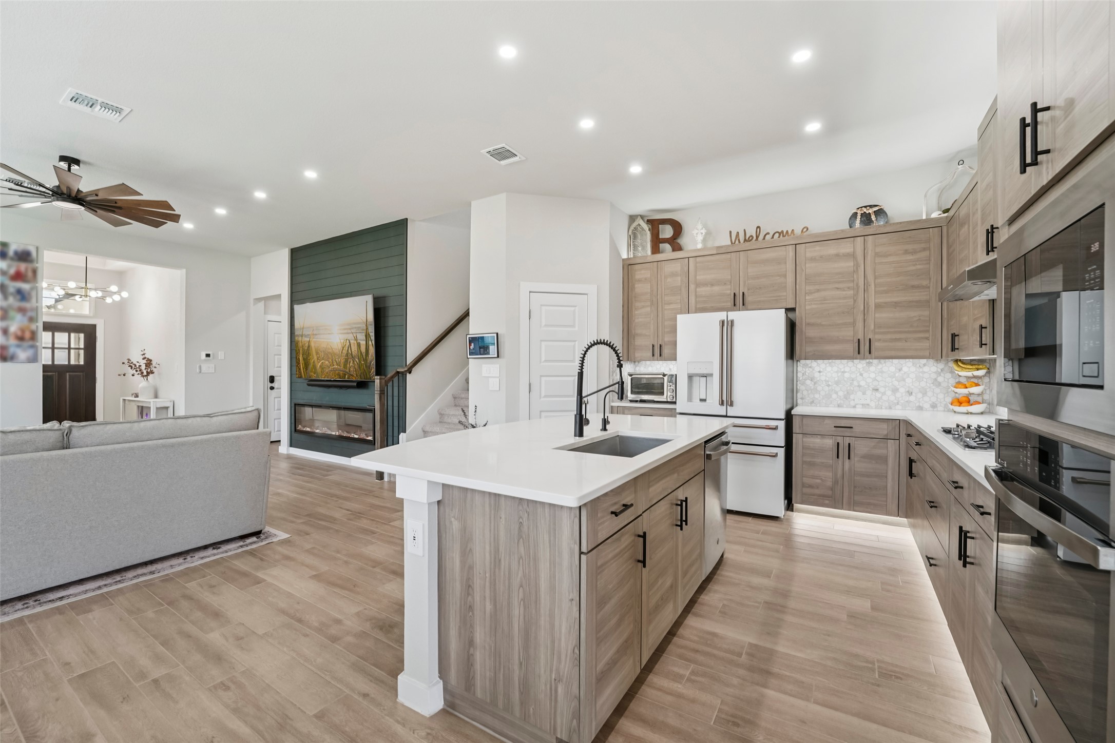 1108 Sweetspire Street Leander, TX 78641 - Photo 39 of 39 a kitchen with stainless steel appliances granite countertop a sink stove and refrigerator