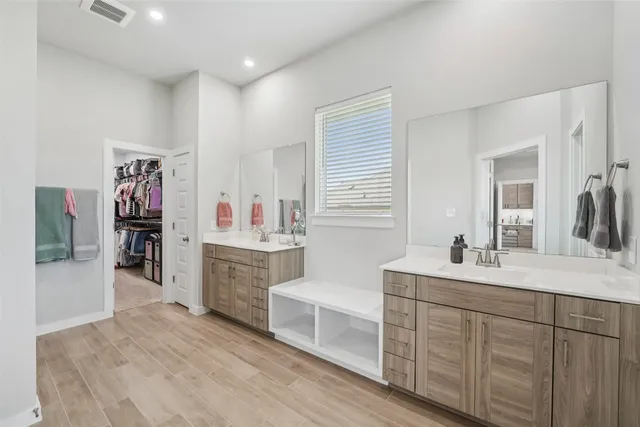 a spacious bedroom with a large bed and a chandelier