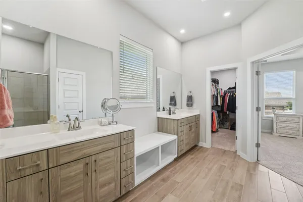 a bathroom with a sink double vanity and a tub