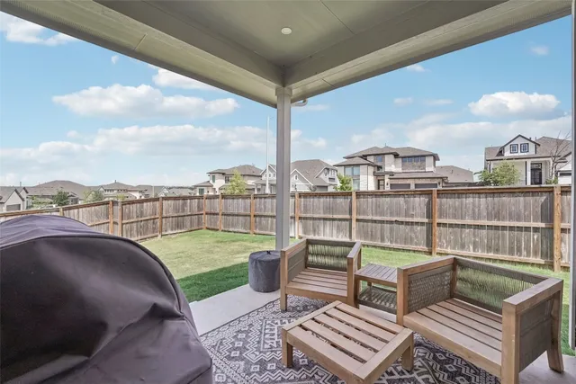 an empty room with a ceiling fan and window