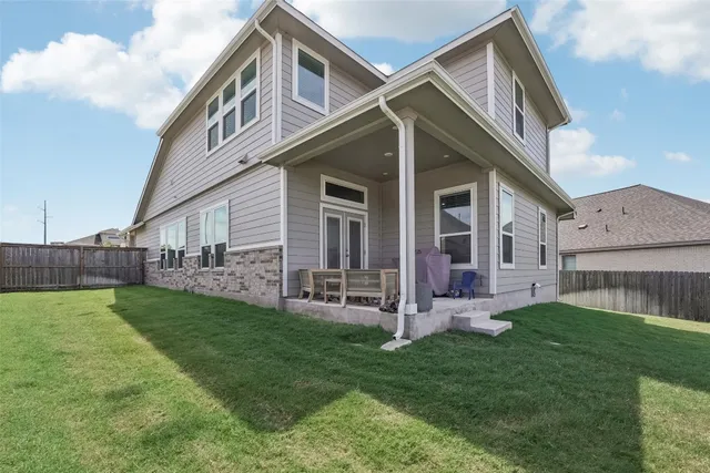 an empty room with closet and a ceiling fan
