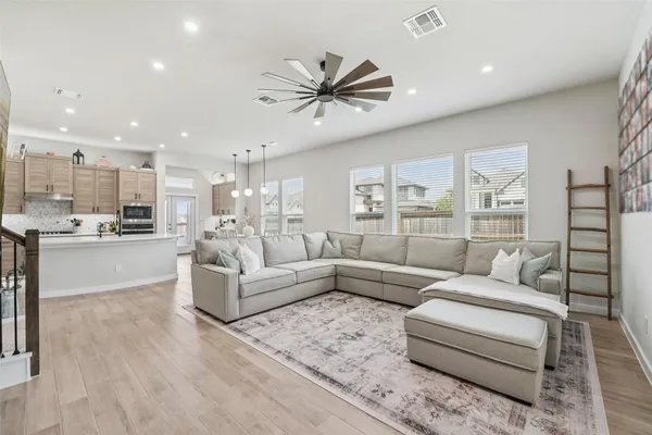 a living room with furniture and kitchen view
