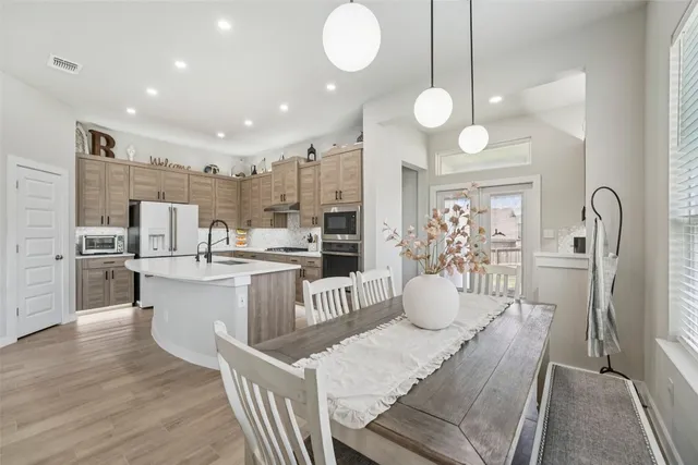 a kitchen with counter space appliances and a chandelier