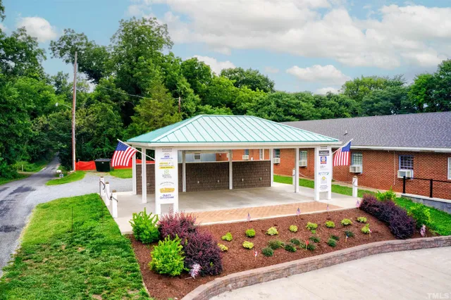 a view of a lake with chairs and table