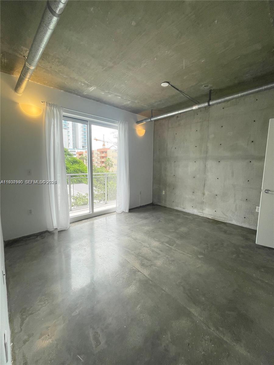 455 Northeast 25th Street, Unit 407 Miami, FL 33137 - Photo 12 of 50 an empty room with windows