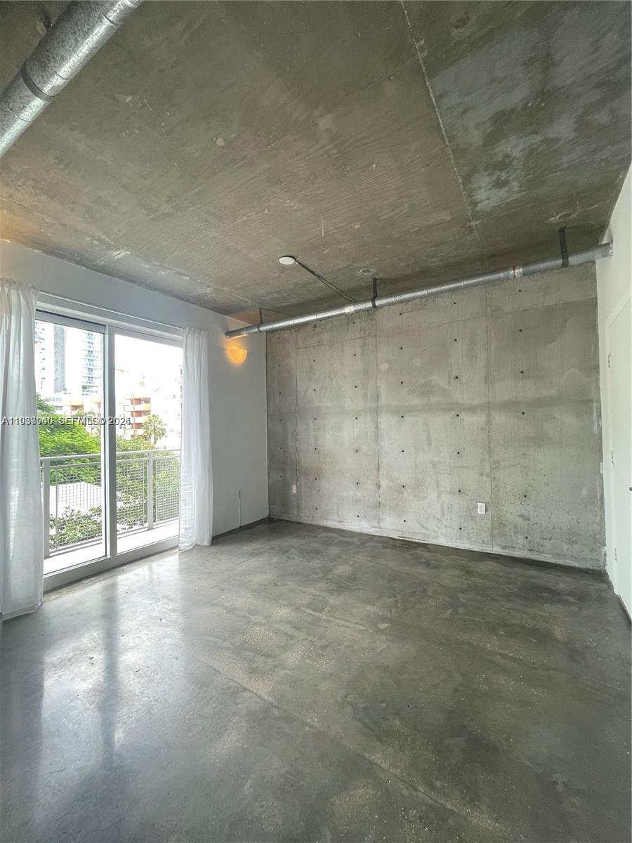 455 Northeast 25th Street, Unit 407 Miami, FL 33137 - Photo 13 of 50 wooden floor in an empty room with a window