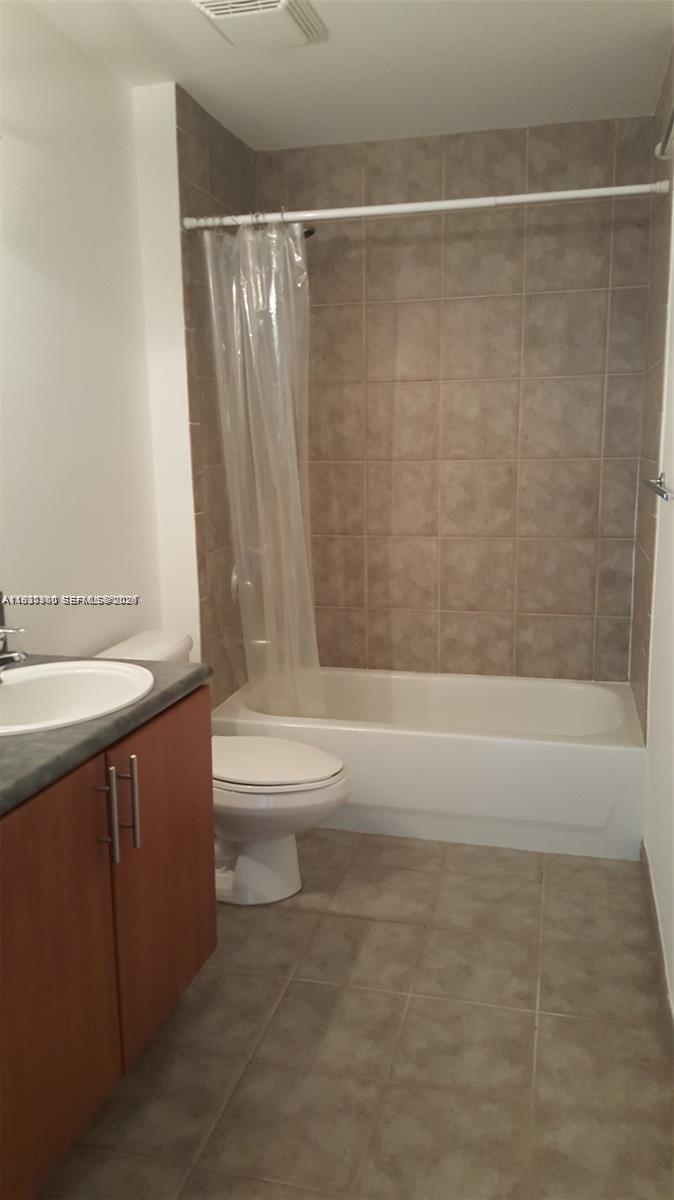 455 Northeast 25th Street, Unit 407 Miami, FL 33137 - Photo 27 of 50 a bathroom with a sink a toilet and a bathtub